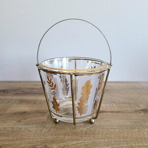 Vintage midcentury gold leaves glass ice bucket with handle and brass stand.